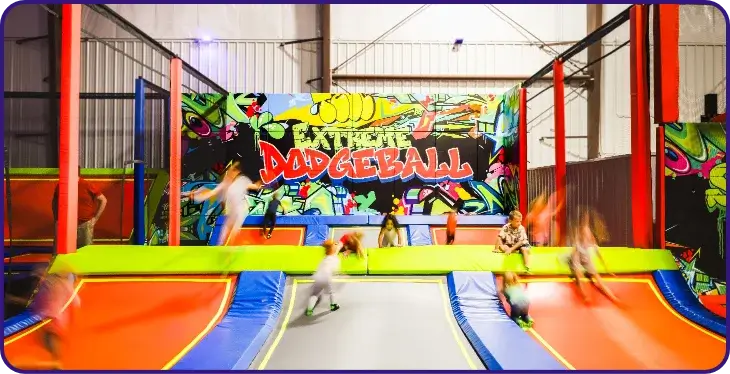 Dodgeball area with kids jumping on trampolines.
