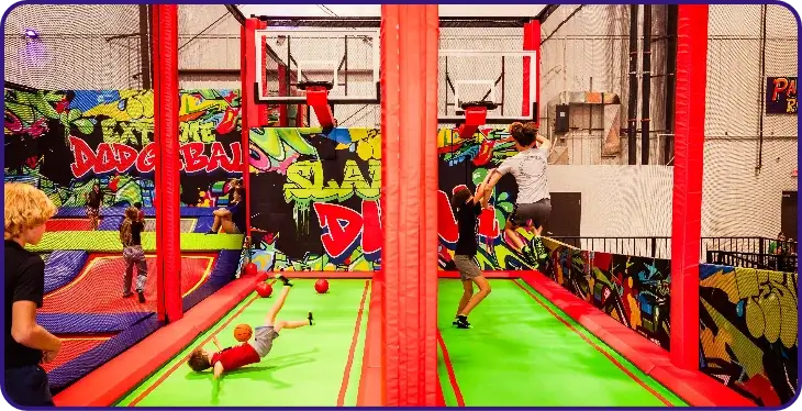 Trampoline dodgeball area with basketball hoops.